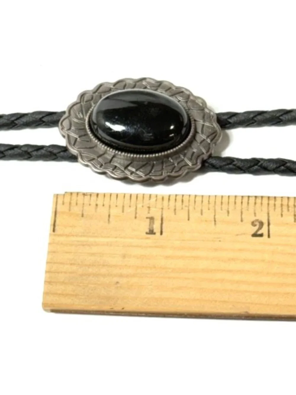 Pewter-tone, black stone, black cord western cowboy bolo tie.